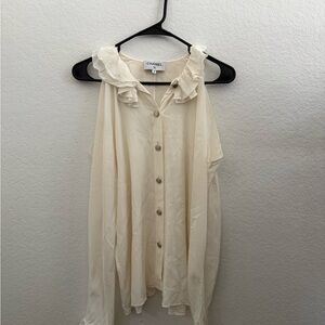CHANEL Elegant Cream Off-The-Shoulder Blouse with Silver Buttons